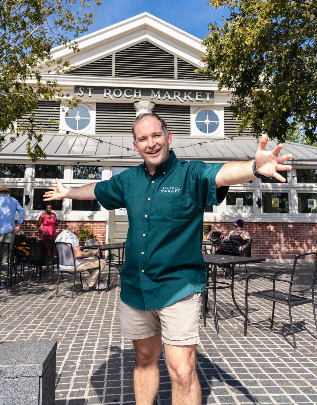 Kevin Pedeaux with arms open in front of St. Roch Market in New Orleans